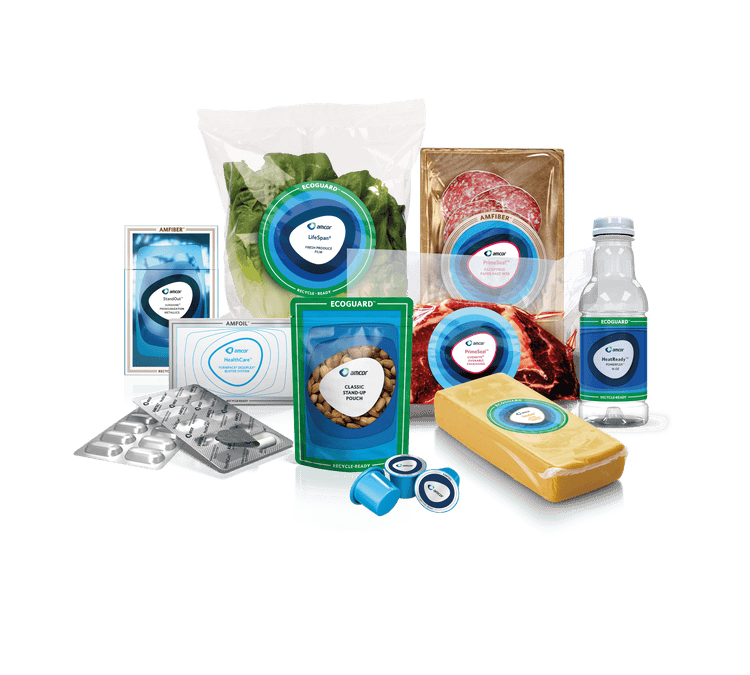 A variety of Amcor packaging solutions displayed, including clear pouches for leafy greens, vacuum-sealed meat packaging, a plastic water bottle, snack pouches, and pharmaceutical blister packs. Each product features Amcor branding and labels indicating sustainability initiatives like 'Recycle-Ready,' 'EcoGuard,' and 'LifeSpan' for freshness and environmental responsibility.