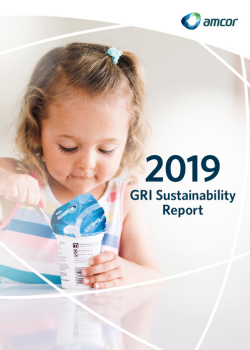 A young child, dressed in a colorful striped shirt, is seen opening a yogurt container with a spoon. The yogurt packaging prominently features the &#34;Amcor&#34; logo, highlighting their sustainable packaging solutions. The title &#34;2019 GRI Sustainability Report&#34; is displayed to the right, emphasizing the focus on sustainability practices for that year. The soft, minimalistic background and the presence of the child convey a message of future generations benefiting from sustainable packaging.