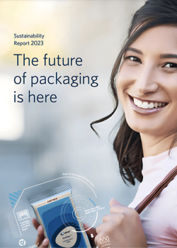 A close-up of a smiling woman holding a package, showcasing a modern design with technical and sustainable packaging elements. The text on the image reads &#34;Sustainability Report 2023&#34; and &#34;The future of packaging is here.&#34; The background is slightly blurred, emphasizing the person and the package, symbolizing progress in sustainable packaging solutions.